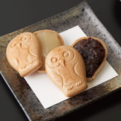 Taiyaki but with an owl design instead of the usual fish. There, are two, split open to reveal fillings of custard and red bean.